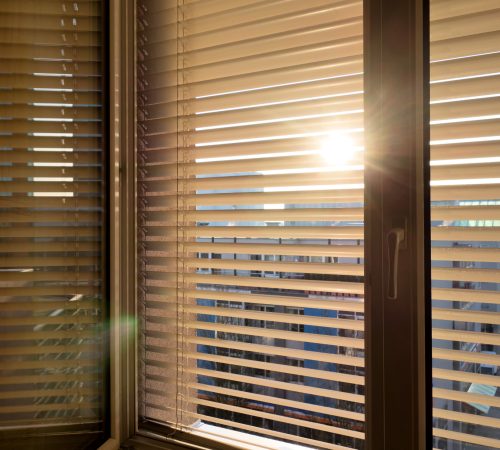 to protect against heat and sun blinds are attached to a window.